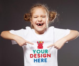 girl pointing to a shirt that says, "you're design here"