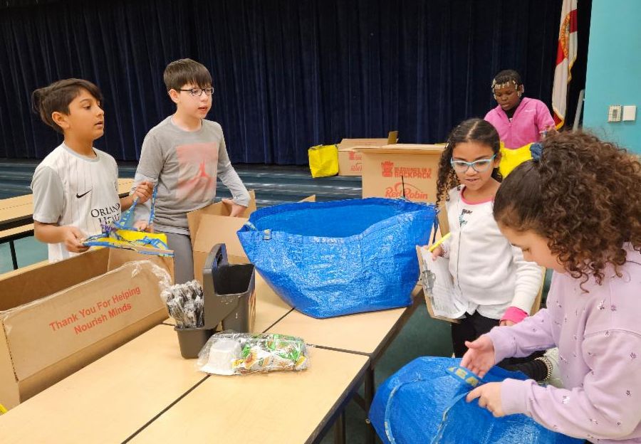 Dramatic Ed Extended Day Students Pack Weekend Food for Classmates at Sally Ride Elementary